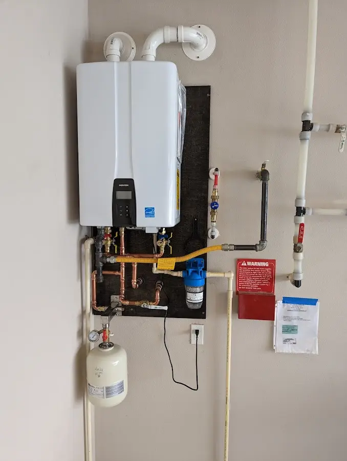 Professional plumber installing copper piping in a Festus home